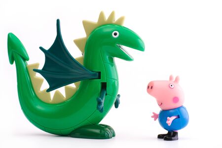 Tambov, Russian Federation - December 16, 2015 George Pig  toy character with green dinosaur on white background. Studio shot.のeditorial素材