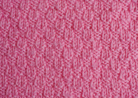 Pink hand knitted texture, Close-up.