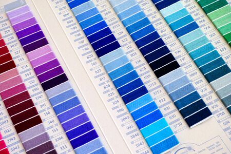 Tambov, Russian Federation - April 11, 2015 DMC Stranded Cotton Shade Card. This shade card contains actual threads arranged onto card with their numbers. Studio shot.のeditorial素材