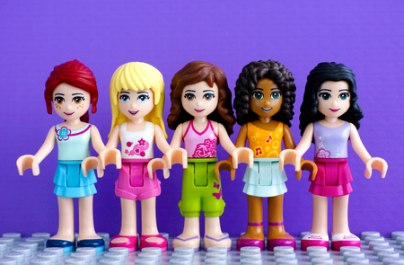 Tambov, Russian Federation - April 01, 2016 Lego friends girl - Andrea, Emma, Mia, Olivia and Stephanie, standing in a row. Purple background. Studio shot.のeditorial素材