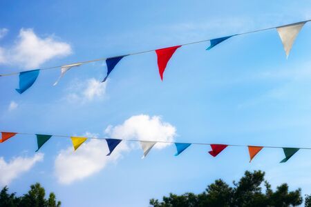 Colorful decoration flags against blue sky background.の写真素材