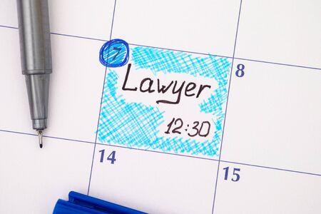 Reminder Lawyer 12-30 in calendar with blue pen.の写真素材
