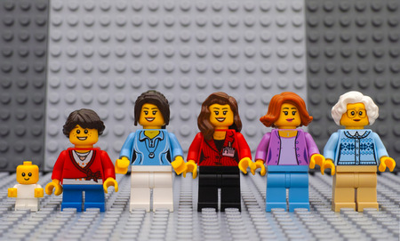 Tambov, Russian Federation - July 06, 2016 Six Lego woman minifigures of different age - from baby to old lady - with gray baseplates background. Studio shot.のeditorial素材