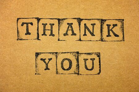 Words Thank You make by black alphabet stamps on cardboard.の写真素材