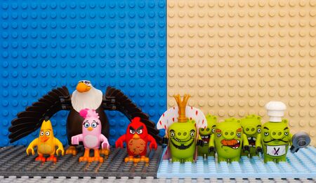Tambov, Russian Federation - July 20, 2016 Lego Angry Birds - Red, Stella, Chuck, Mighty Eagle - versus Bad Piggies - King Pig, Chef Pig, Foreman Pig and Minion Pigs. Studio shot.のeditorial素材