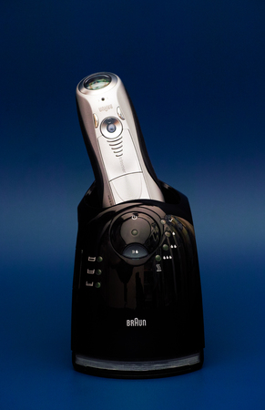 Tambov, Russian Federation - August 19, 2016 Braun Series 7 799cc-7 Wet and Dry shaver with Clean and Charge Station. Blue background. Studio shot.のeditorial素材