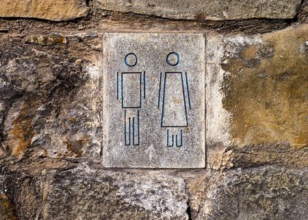 Man and woman symbols on stone wall. Close-upの写真素材