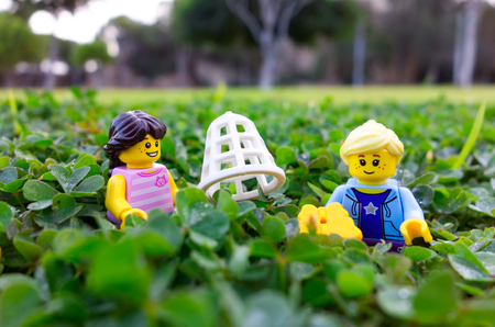 Paphos, Cyprus - October 18, 2016 Two Lego girl minifigures catching butterfly in park.のeditorial素材