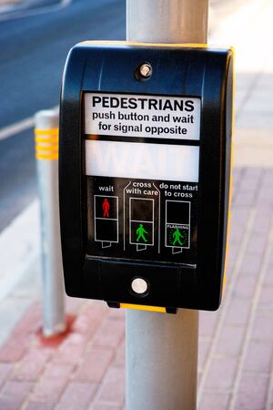 Pedestrians push button in the streetの写真素材