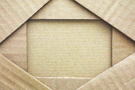 Cardboard frame with piece of cardboard. Full frame. の写真素材