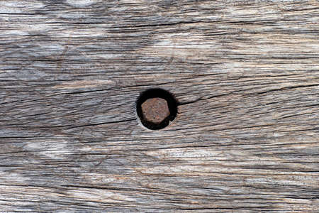 Wooden background with rusty screw. Full frame.