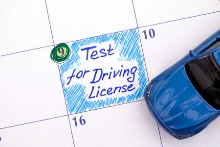 Reminder Test for Driving License in calendar with blue car toy.の写真素材