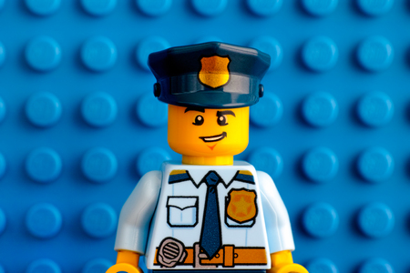 Tambov, Russian Federation - June 03, 2017 Portrait of Lego policeman minifigure with blue baseplate background. Studio shot.のeditorial素材