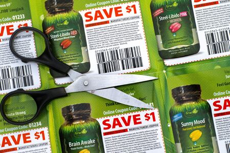 Tambov, Russian Federation - June 18, 2017 Irwin Naturals discount coupons with scissors.のeditorial素材