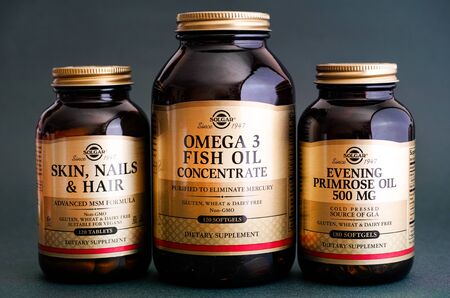 Tambov, Russian Federation - August 22, 2017 Three Solgar bottles with dietary supplement - Skin, Nail and Hair formula, Omega 3 Fish Oil Concentrate and Evening Primrose Oil.  Studio shot.のeditorial素材