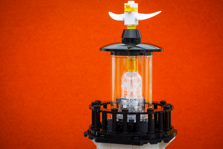 Tambov, Russian Federation - June 15, 2017 Top of Lego Lighthouse with seagull on orange background. Studio shot.のeditorial素材