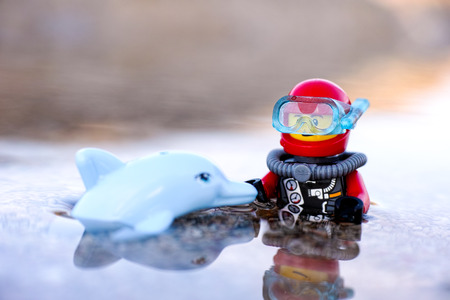 Paphos, Cyprus - October 09, 2016 Lego scuba diver and dolphin minifigures in the sea. Shallow depth of field.のeditorial素材