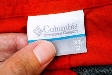 Tambov, Russian Federation - September 27, 2017 Person hand with Columbia Sportswear Company clothes label.のeditorial素材