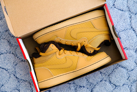 Tambov, Russian Federation - September 28, 2017 New Nike court borough mid winter sport shoes in the box. Blue background.のeditorial素材