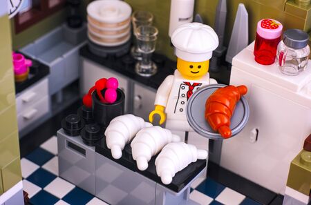 Tambov, Russian Federation - January 04, 2018 Lego chef preparing croissant in the kitchen. Studio shot.のeditorial素材