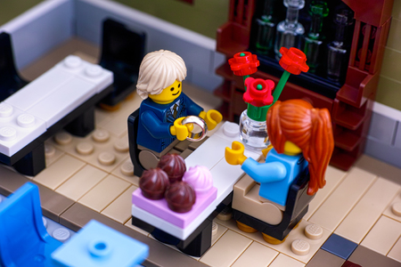 Tambov, Russian Federation - January 04, 2018 Lego couple in Restaurant. Man gets ready to propose with the ring. Studio shot.のeditorial素材