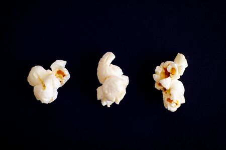 Three popcorns on black background. Close-up.の写真素材
