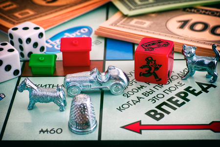 Tambov, Russian Federation - January 26, 2018 Monopoly Board Game. Field Go of gameboard with tokens, dices, money and houses. Studio shot.のeditorial素材