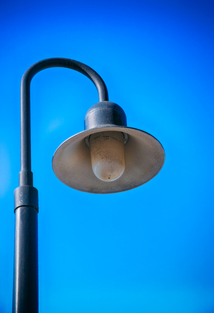 Street lamp against blue sky. Close-up.