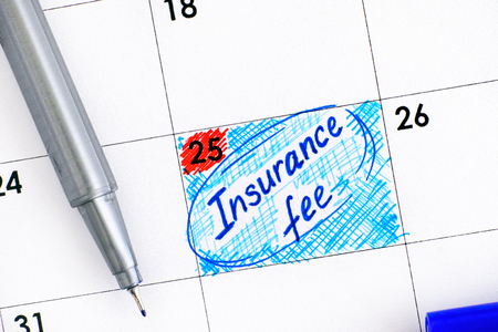 Reminder Insurance Fee in calendar with blue pen. Close-up.の写真素材