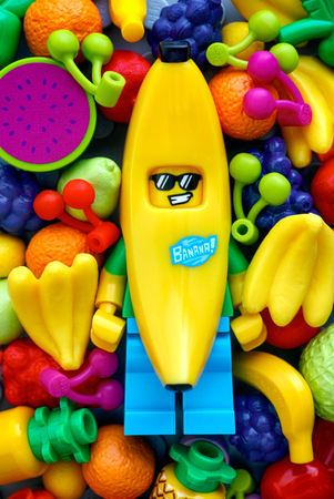 Tambov, Russian Federation - May 20, 2018 Lego Banana Guy minifigure with fruits background. Studio...