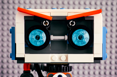 Tambov, Russian Federation - July 27, 2018 Close-up of Lego BOOST robot head with blue eyes against gray baseplate background. Studio shot.のeditorial素材