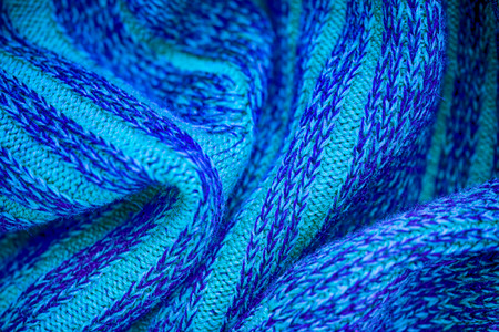 Blue hand knitted sweater. Close-up.