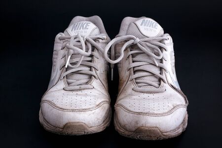 Tambov, Russian Federation - January 23, 2016 Old dirty white Nike View III sneakers on black background. Close-up.のeditorial素材
