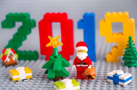 Tambov, Russian Federation - September 02, 2018 Christmas tree, Santa Clause with bag and presents against  numbers 2019 made by Lego blocks on gray baseplates. New Year concept. Studio shot.のeditorial素材