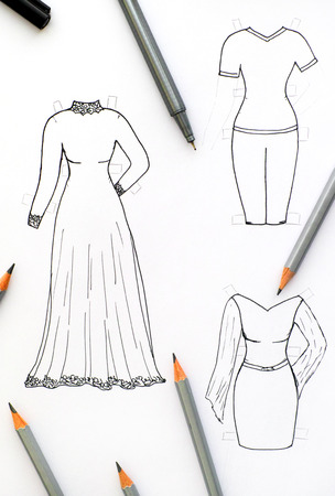 Hand drawing clothes for paper doll with black pen and pencils.の写真素材