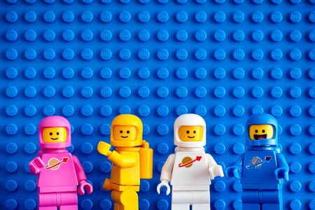 Tambov, Russian Federation - February 24, 2019 Four Lego astronaut minifigures against blue baseplate background. The LEGO Movie 2.のeditorial素材