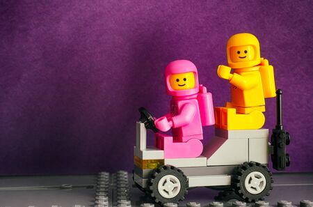 Tambov, Russian Federation - February 24, 2019 Two Lego astronaut minifigures -  Lenny and Kenny, on Lunar buggy against purple background. The LEGO Movie 2.のeditorial素材