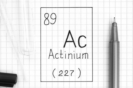 The Periodic table of elements. Handwriting chemical element Actinium Ac with black pen, test tube and pipette. Close-up.の写真素材