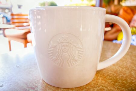 Paphos, Cyprus - October 24, 2013 Close-up of white Starbucks Mug on the table outdoors.のeditorial素材