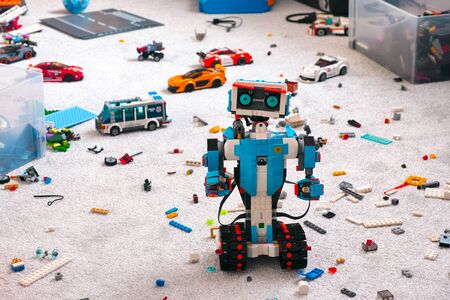 Tambov, Russian Federation - June 16, 2019 Lego BOOST robot standing on room floor with other Lego toys, bricks and baseplates.のeditorial素材