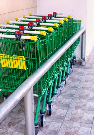 Shopping Trolley standing in a row outdoors.の写真素材