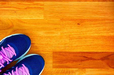 Blue and pink running shoes on wooden floor. Close-up.の写真素材