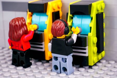Tambov, Russian Federation - October 30, 2019 Lego boy and girl playing slot machines.