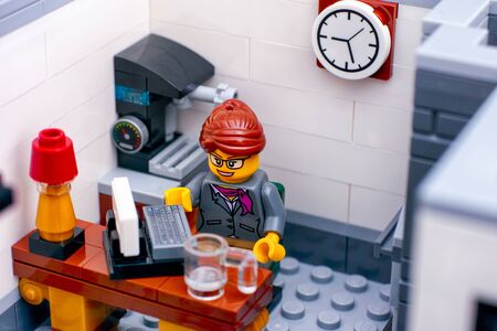 Tambov, Russian Federation - October 22, 2019 Lego office worker on her workplace. Studio shot.のeditorial素材