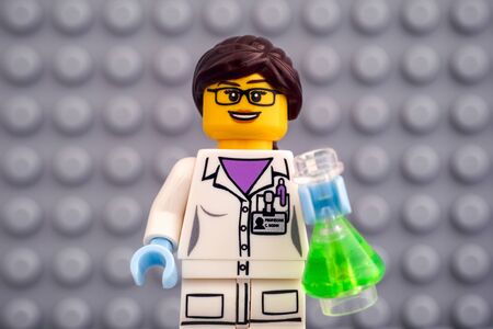 Tambov, Russian Federation - October 19, 2019 Lego scientist minifigure with green flask against...