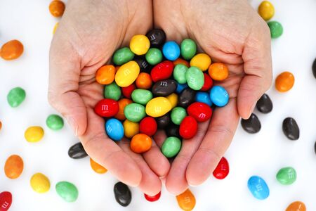 Tambov, Russian Federation - December 05, 2019 M&Ms candy in woman hands.