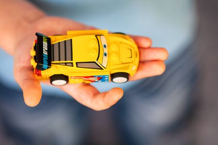 Tambov, Russian Federation - Janyary 29, 2014 Child hand with Lego Jeff Gorvette car. Shallow depth of fieldのeditorial素材