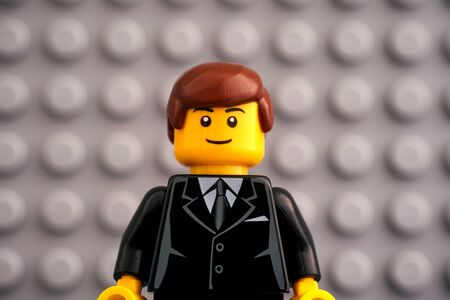 Tambov, Russian Federation - October 19, 2019 Portrait of Lego businessman minifigure with Lego gray baseplate background. Studio shot.のeditorial素材