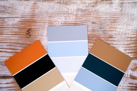 Three multicoloured swatches on wooden background. Close-up.