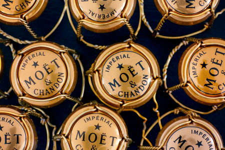 Tambov, Russian Federation - February 14, 2020 A lot of Moet & Chandon Champagne muselets with caps on black background.のeditorial素材